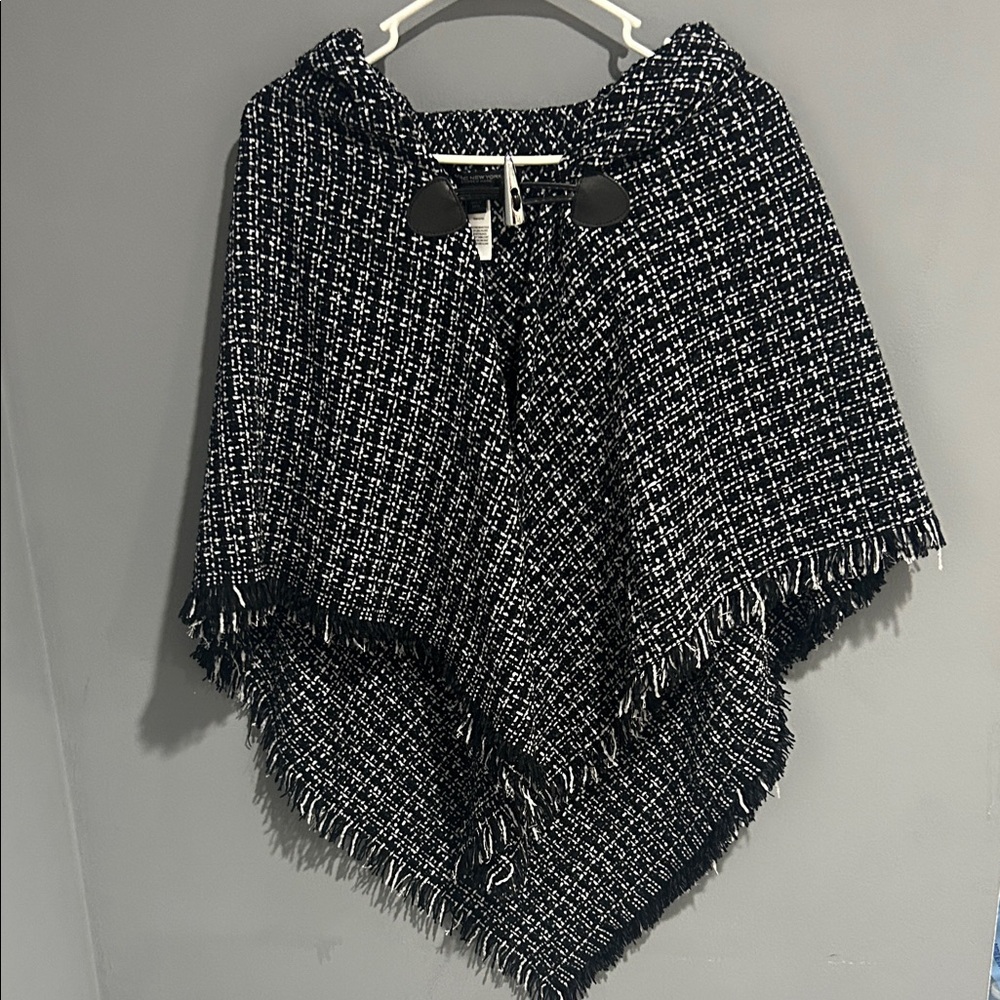 Chic Black and White Poncho has sequins throughout. Very beautiful NWT